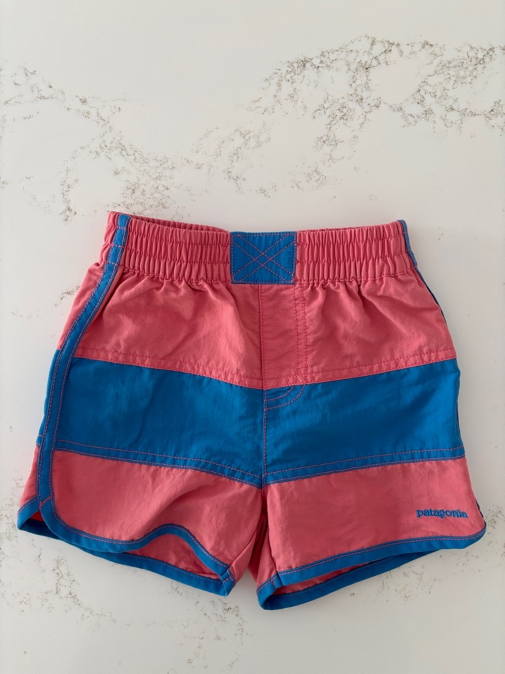 Patagonia Baby Boardshorts Colorblock Swim Shorts. Muted red/pink and blue. 4t